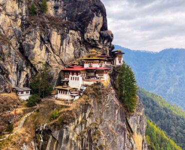 white and red concrete building on top of mountain during daytime