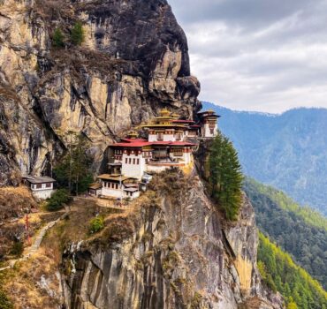 white and red concrete building on top of mountain during daytime