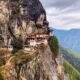 white and red concrete building on top of mountain during daytime